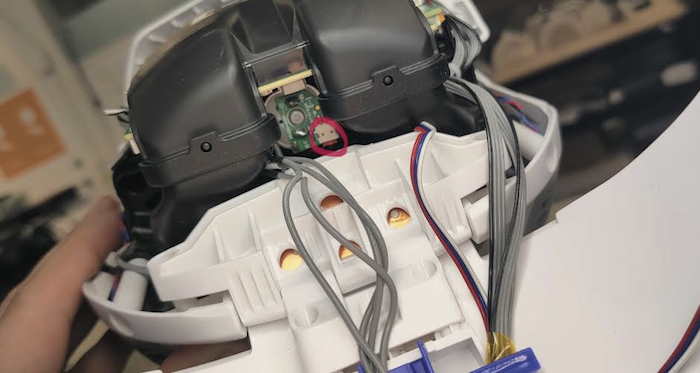 Inside of Misty's opened head showing the motor/encoder connector circled in red
